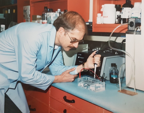 A man pipetting.
